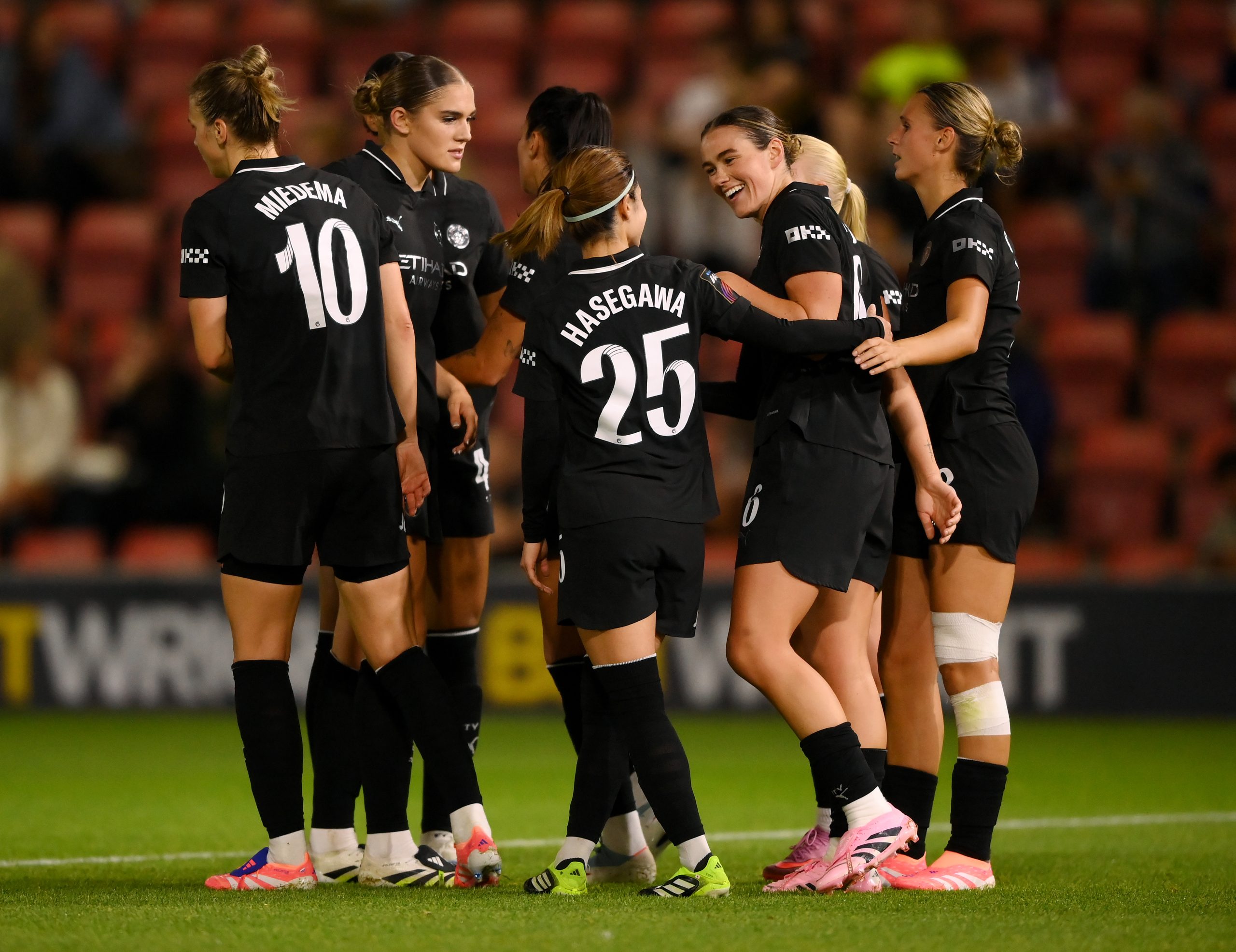 Man City women players celebrate in names and numbers manufactured by ID UNLIMITED