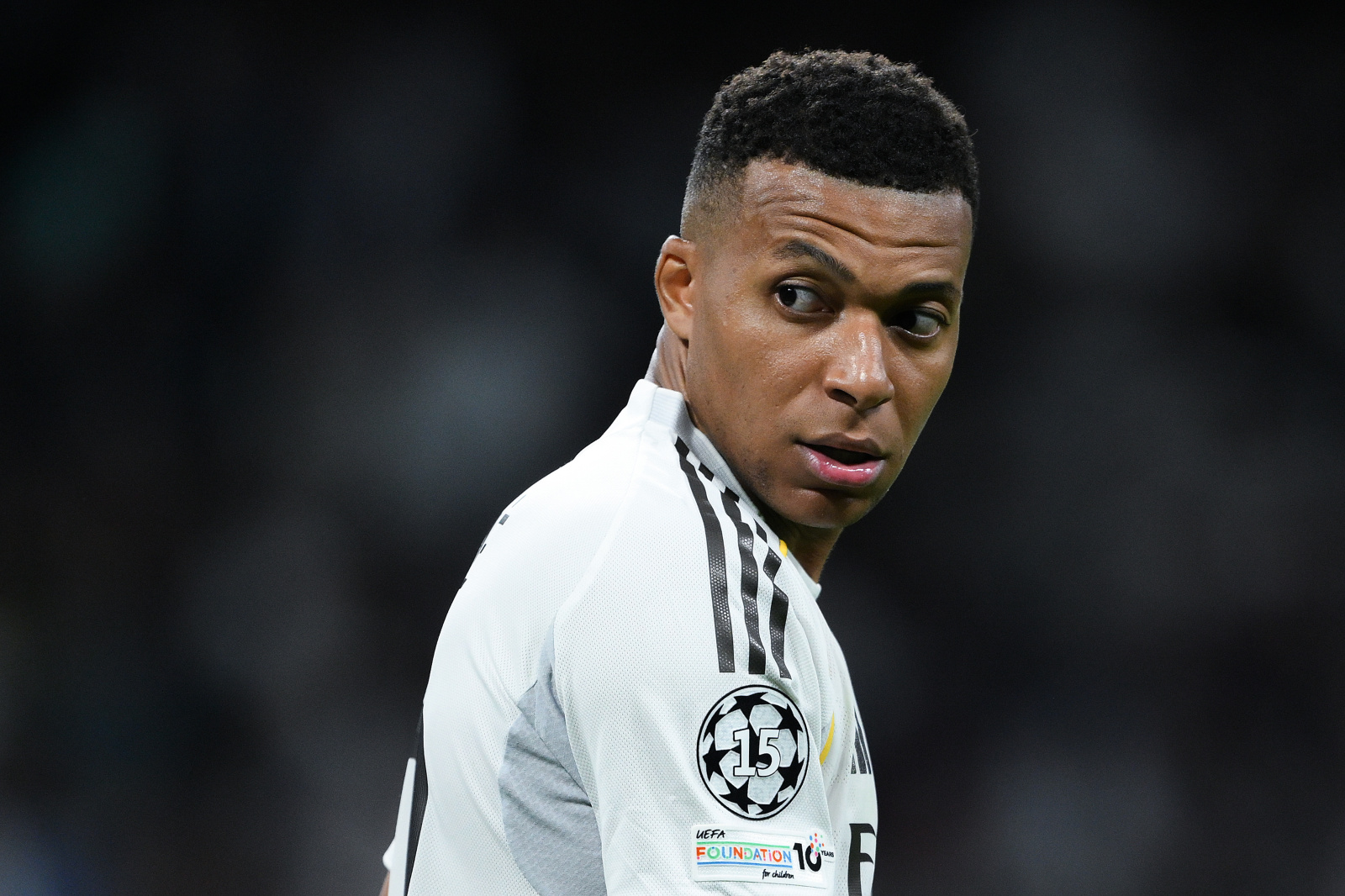 Mbappe wearing an ID UNLIMITED made UCL winners badge